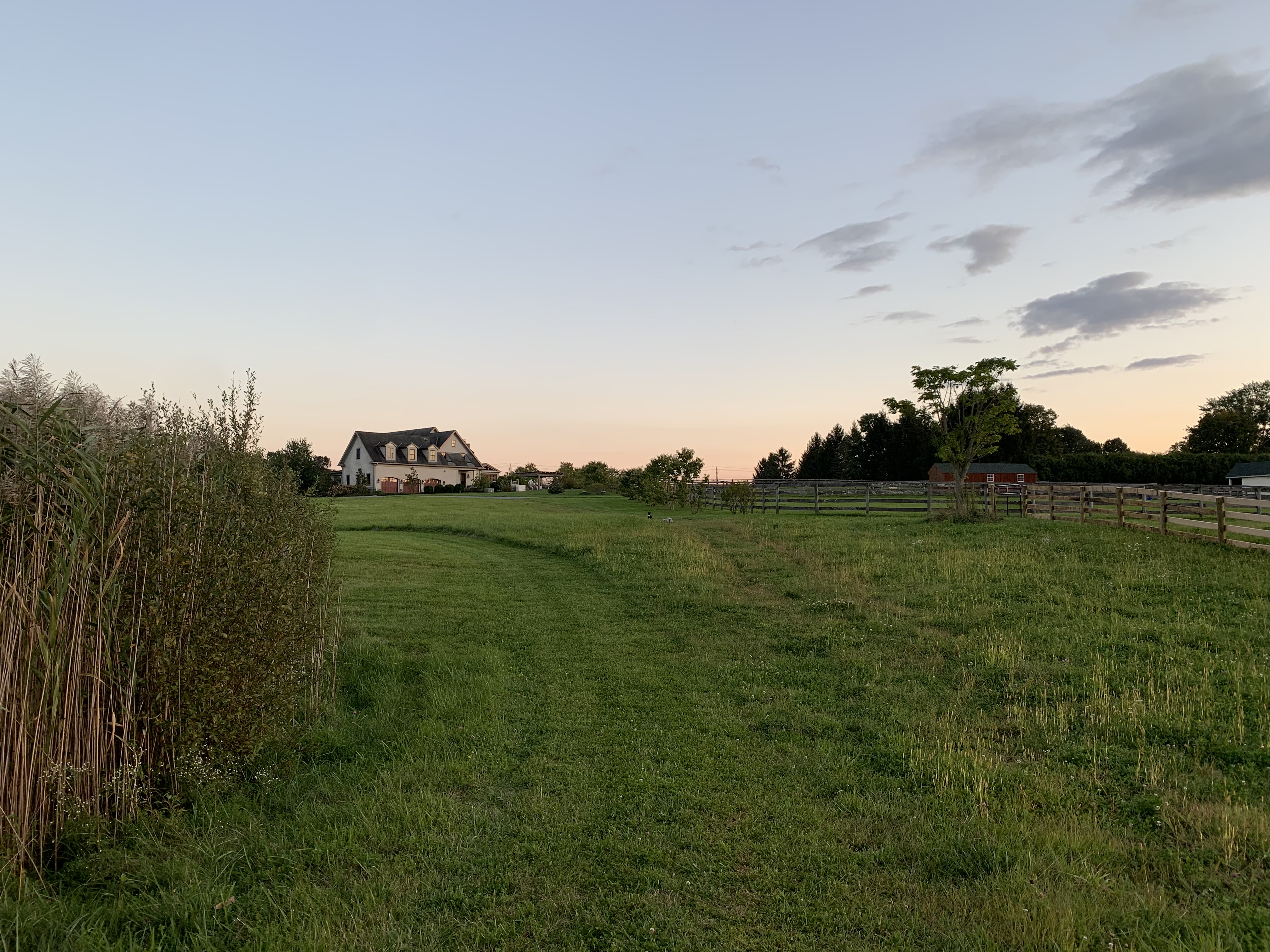 picture of house behind rolling hill